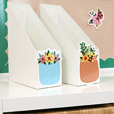 Grow Together cutouts affixed to folder organizers on a teacher's desk.