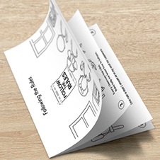 Following the Rules free printable mini book lying on a wood desk.