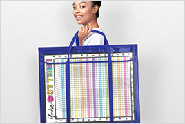 Happy, smiling teacher holding a bulletin board storage pocket chart.