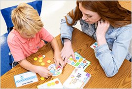 Teacher working with a young student using a Be Clever Wherever Took Kit.