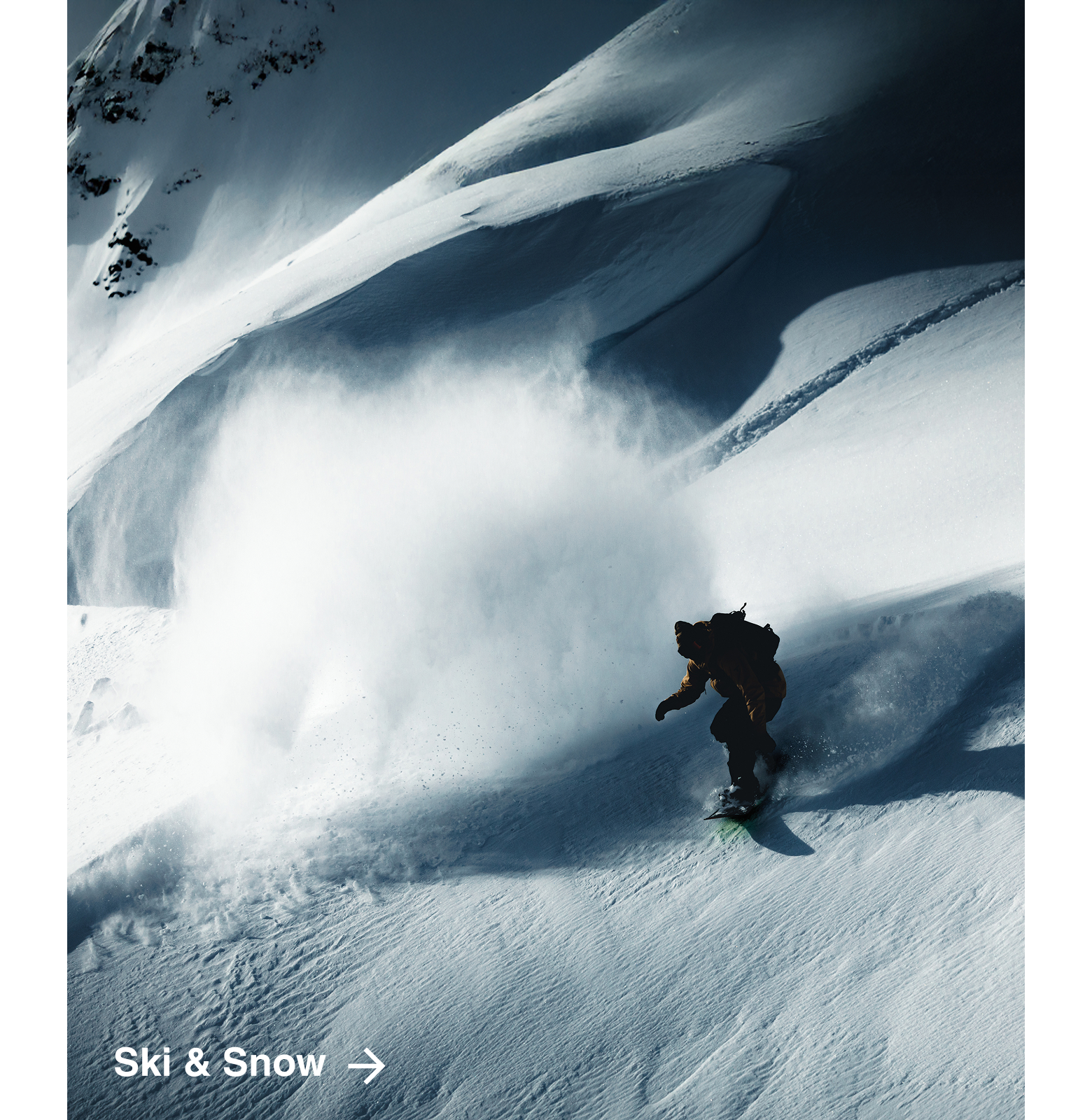 Person in Columbia gear snowboarding down a mountain. 