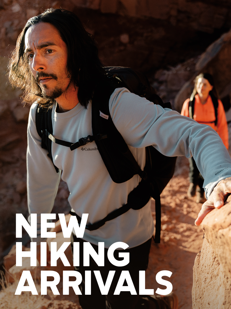 A man and woman hiking through rocky terrain with NEW HIKING ARRIVALS text