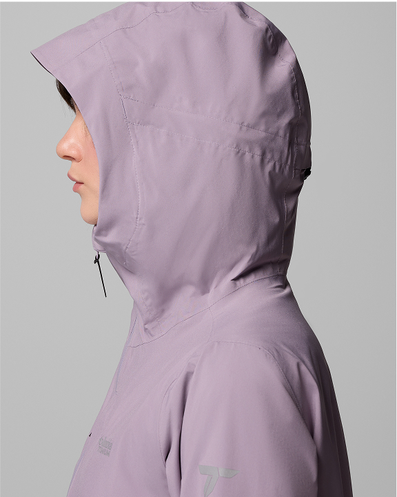 A woman wearing a lavender jacket with the hood up