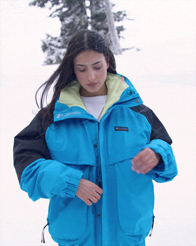 Gif of the model unzipping the inner fleece layer of her Interchange jacket.