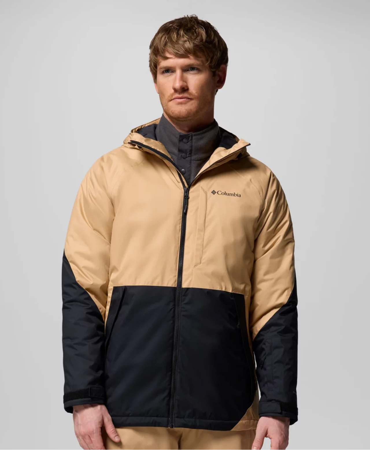 A man wearing a tan ski jacket.