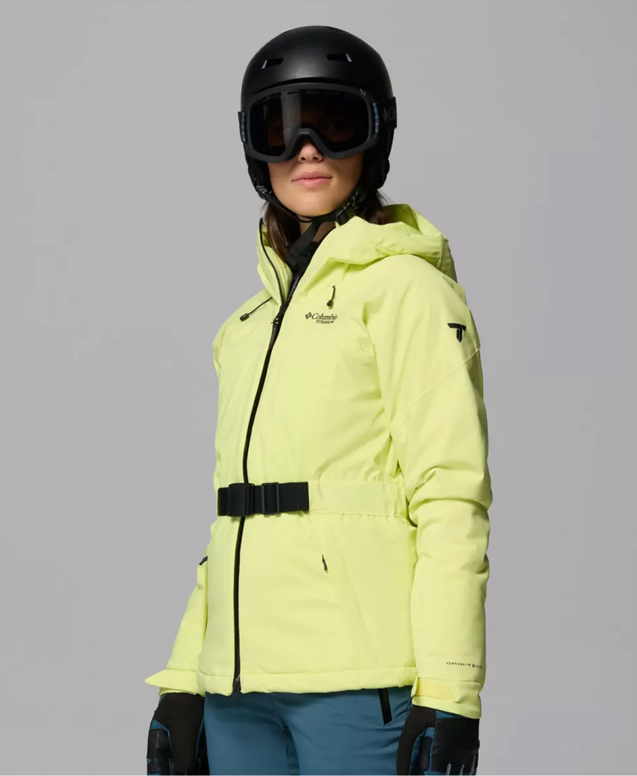 A woman wearing a lime-colored ski jacket.