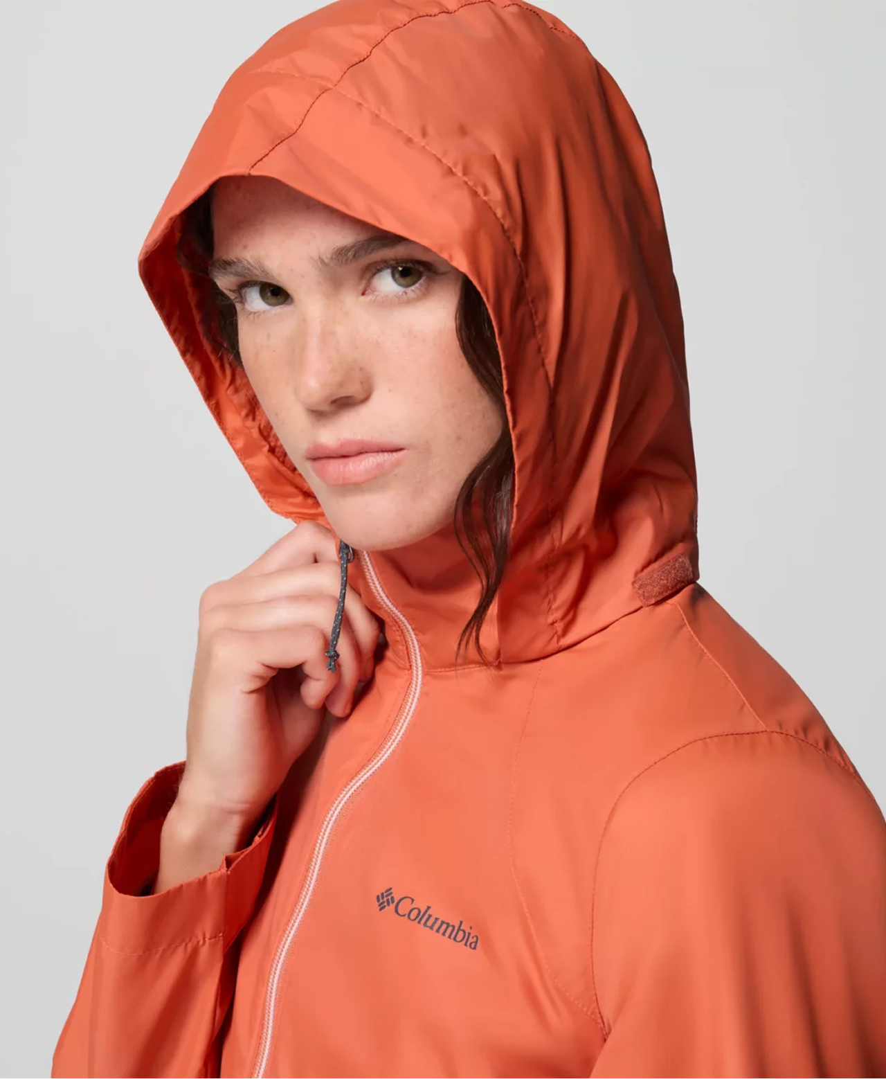A woman wearing an orange rain jacket.