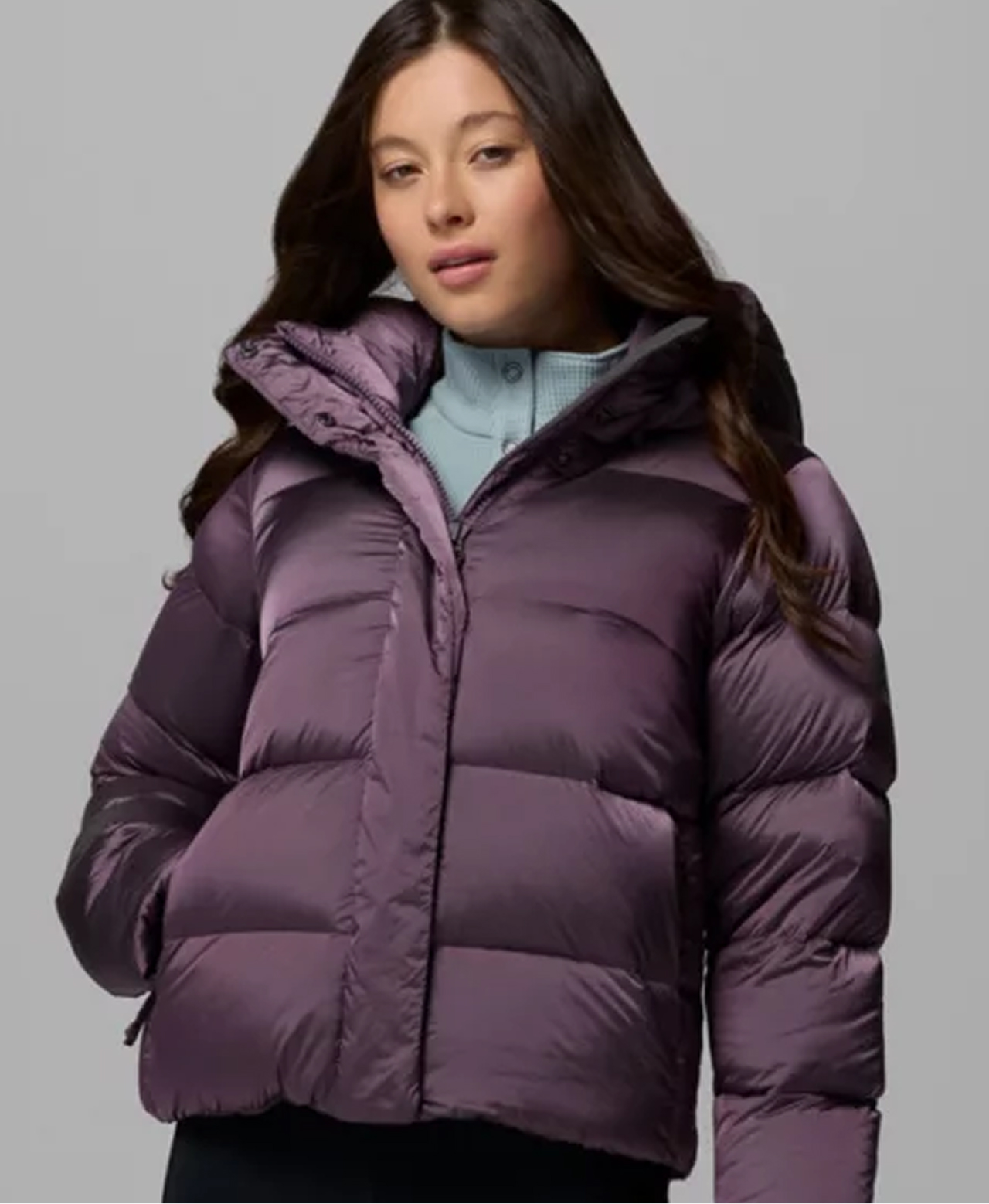 A woman wearing a purple puffer jacket.