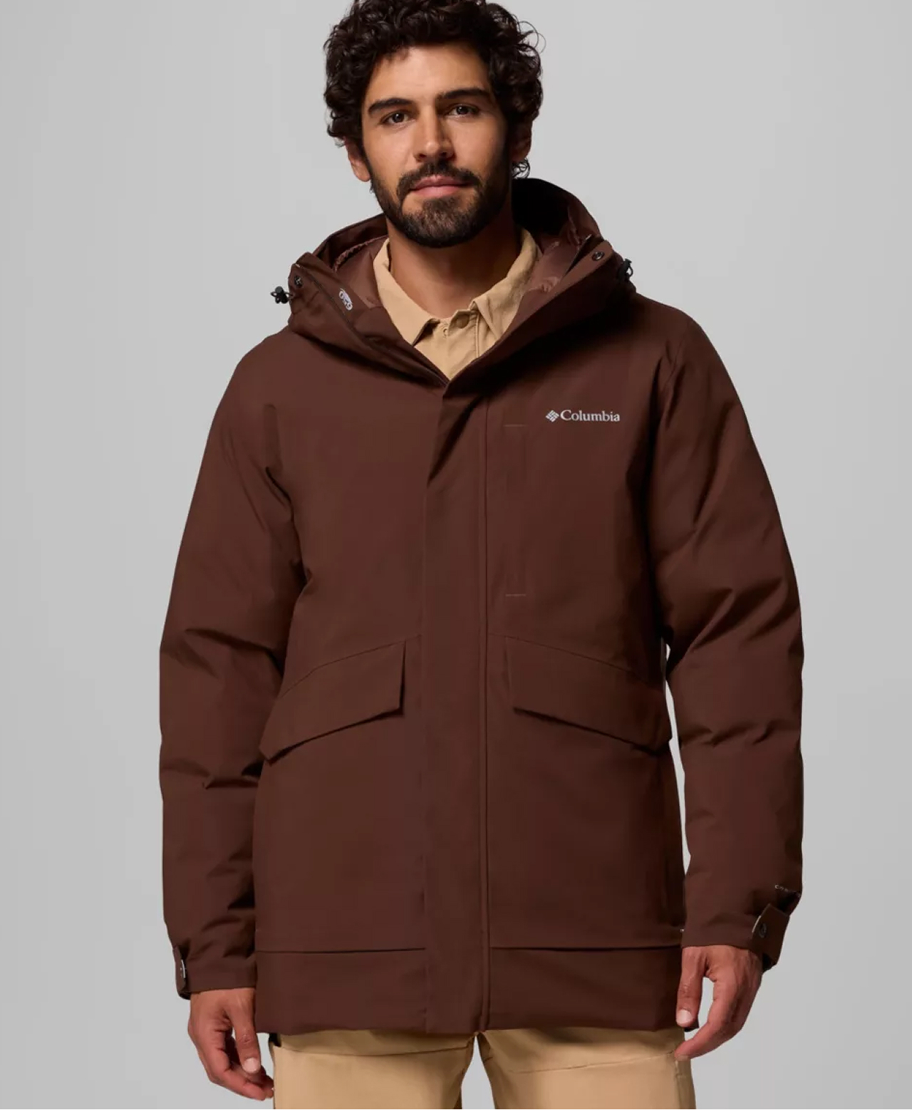 A man wearing a brown winter parka.