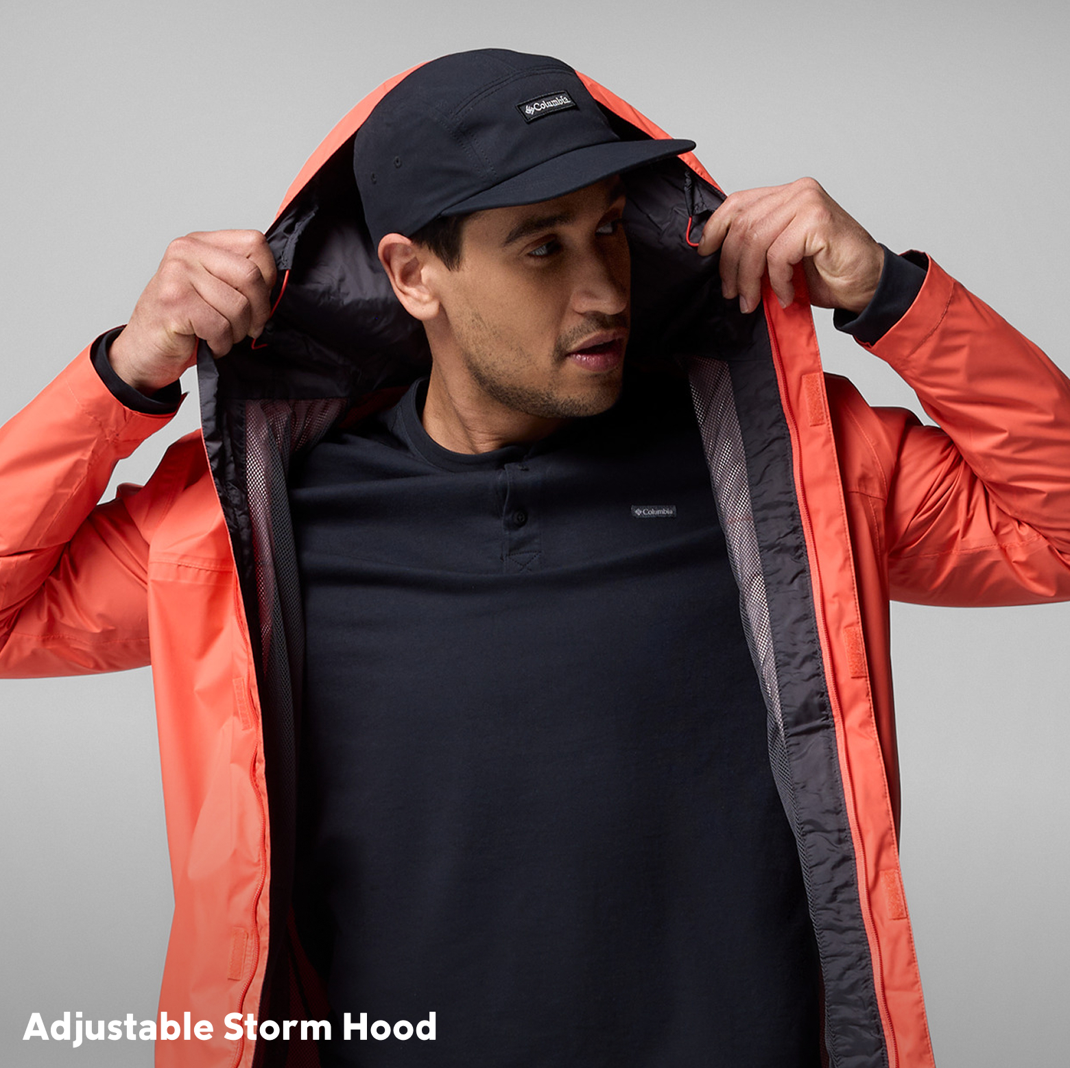 A man putting the hood up on the Watertight II jacket.
