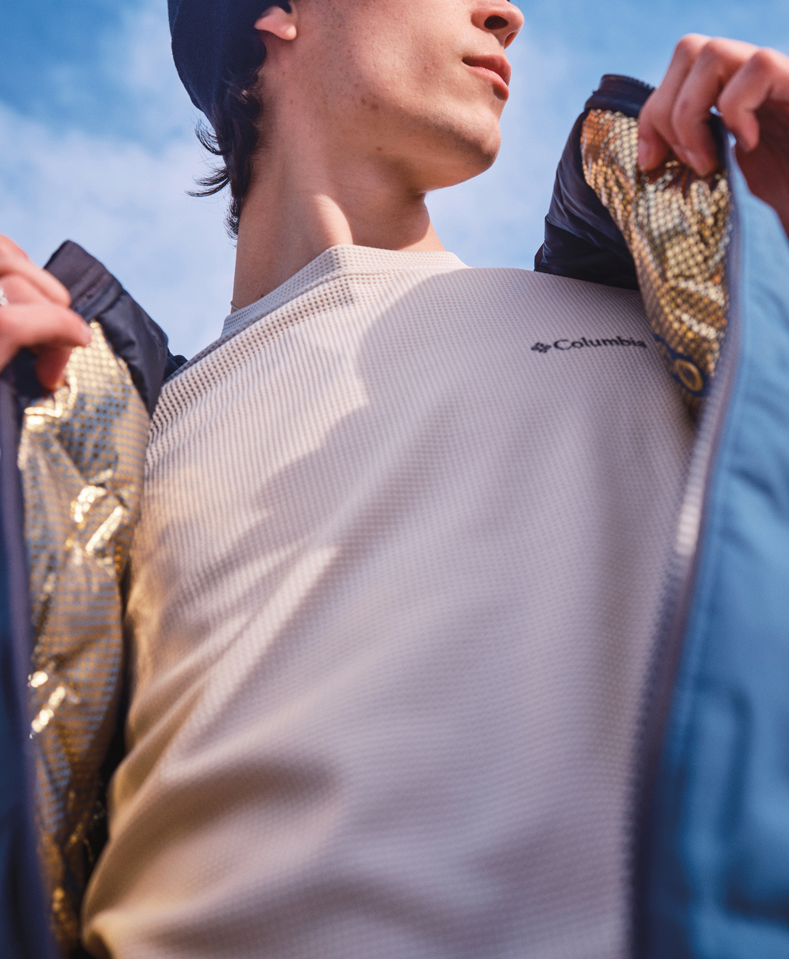 A close-up of a man wearing an open Omni-Heat™ Infinity jacket.
