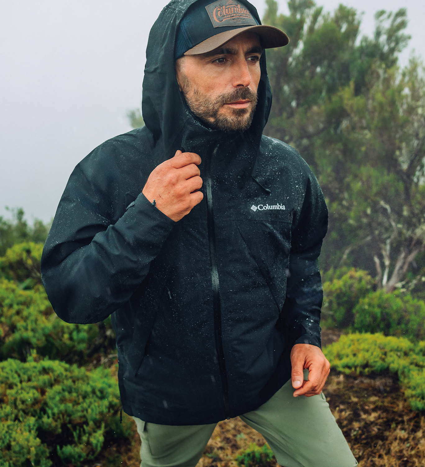A man wearing a black rain jacket