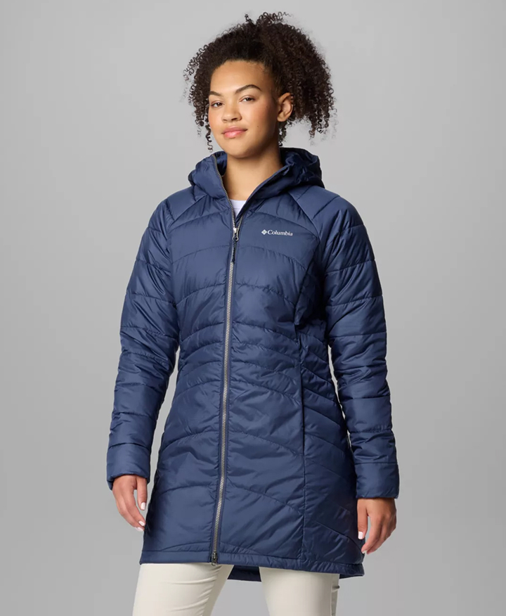 A woman wearing a blue puffer jacket.