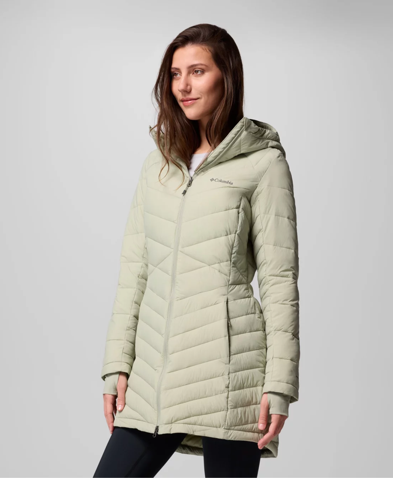 A woman wearing a green Omni-Heat™ Infinity Jacket
