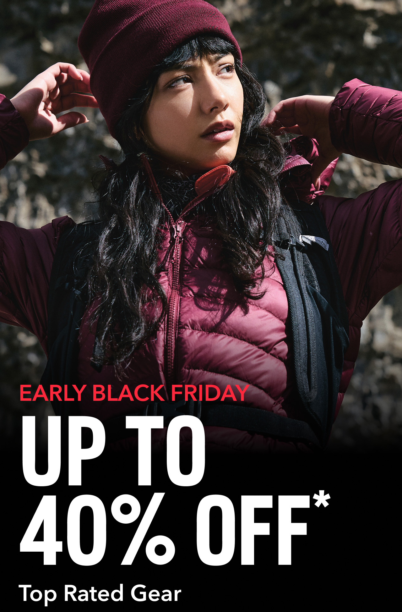 A woman in a rocky landscape wearing a maroon winter jacket with text: EARLY BLACK FRIDAY UP TO 40% OFF*