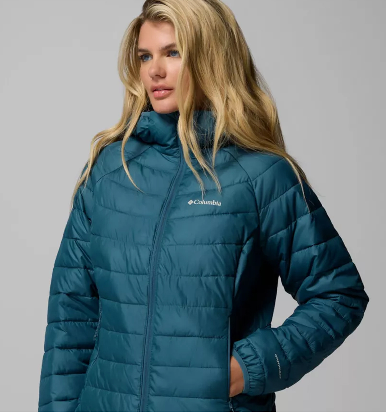 A woman wearing a blue puffer jacket.