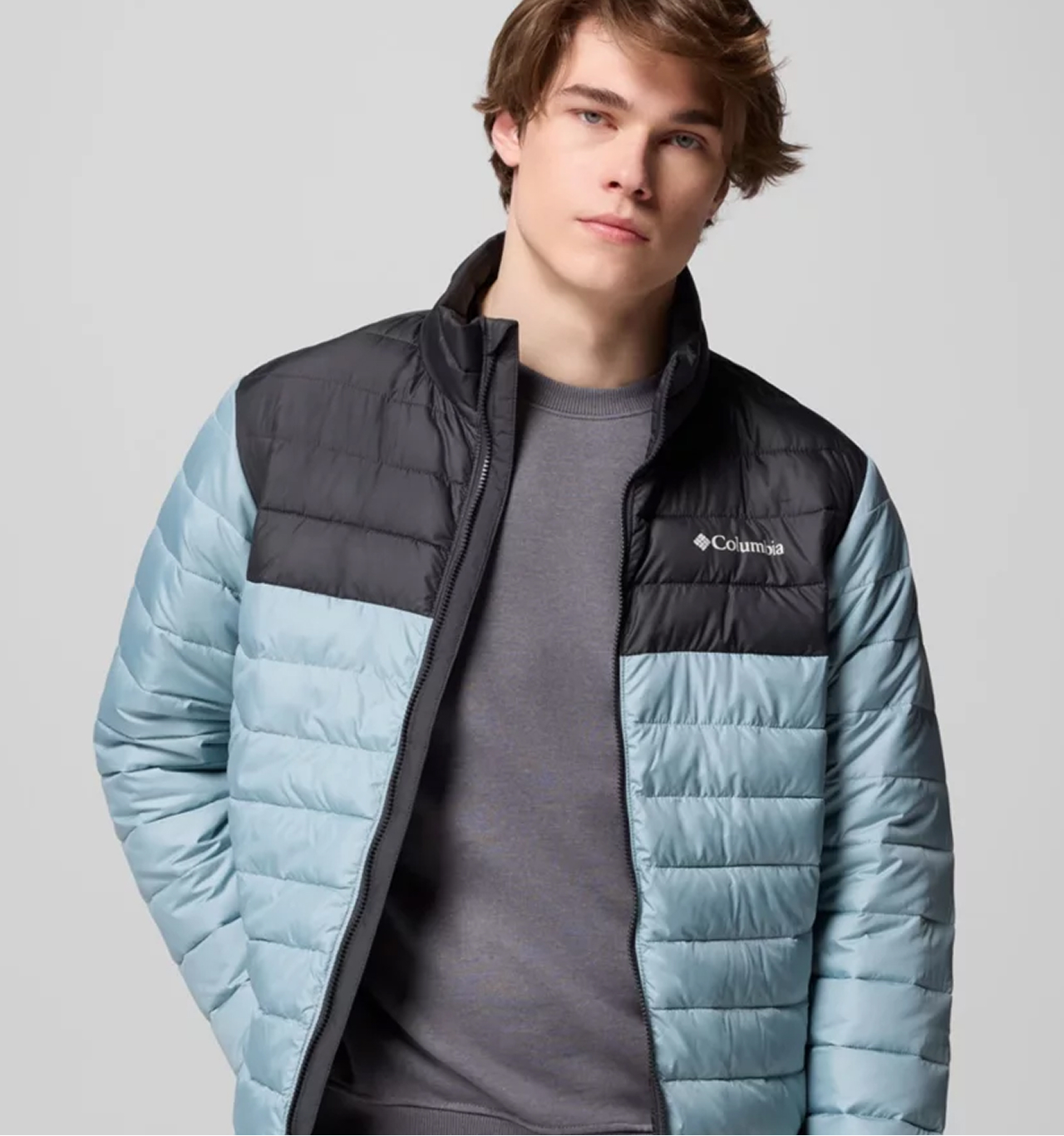 A man wearing a blue puffer jacket.