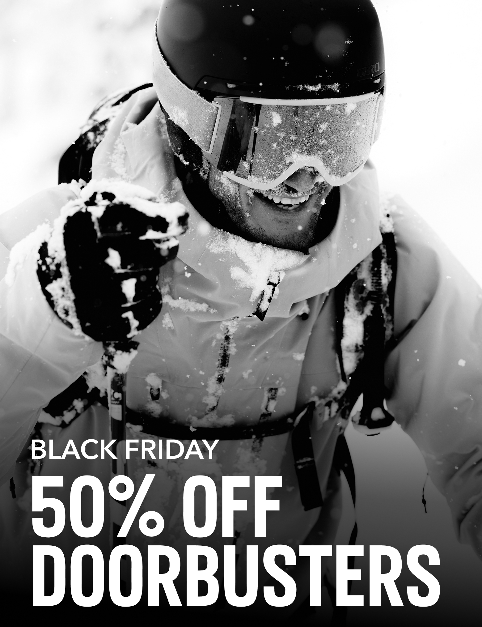 Skier smiling in the snow with text: BLACK FRIDAY 50% OFF DOORBUSTERS
