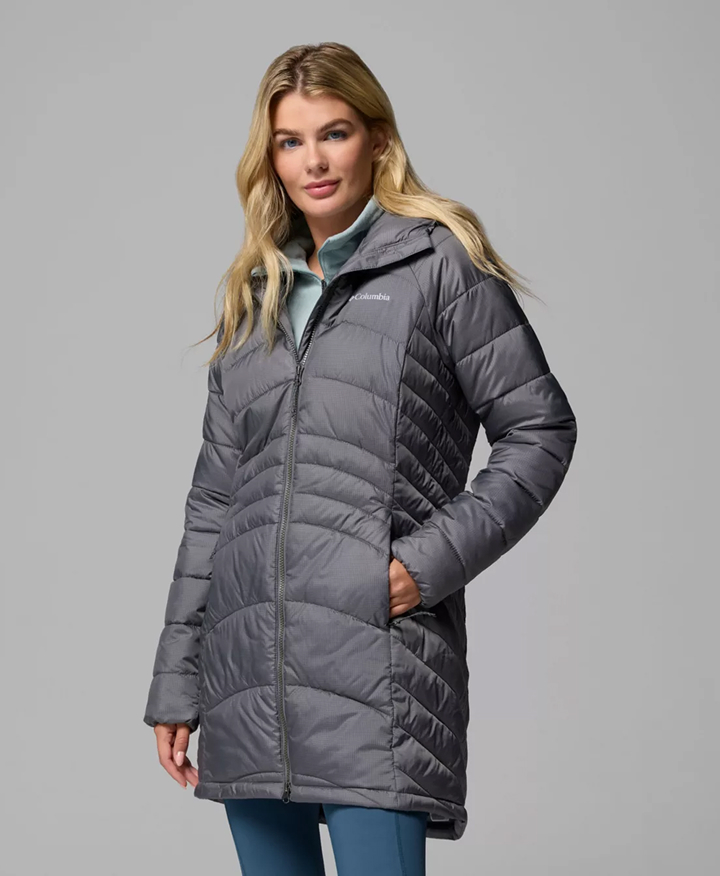 A woman wearing a grey puffer jacket 