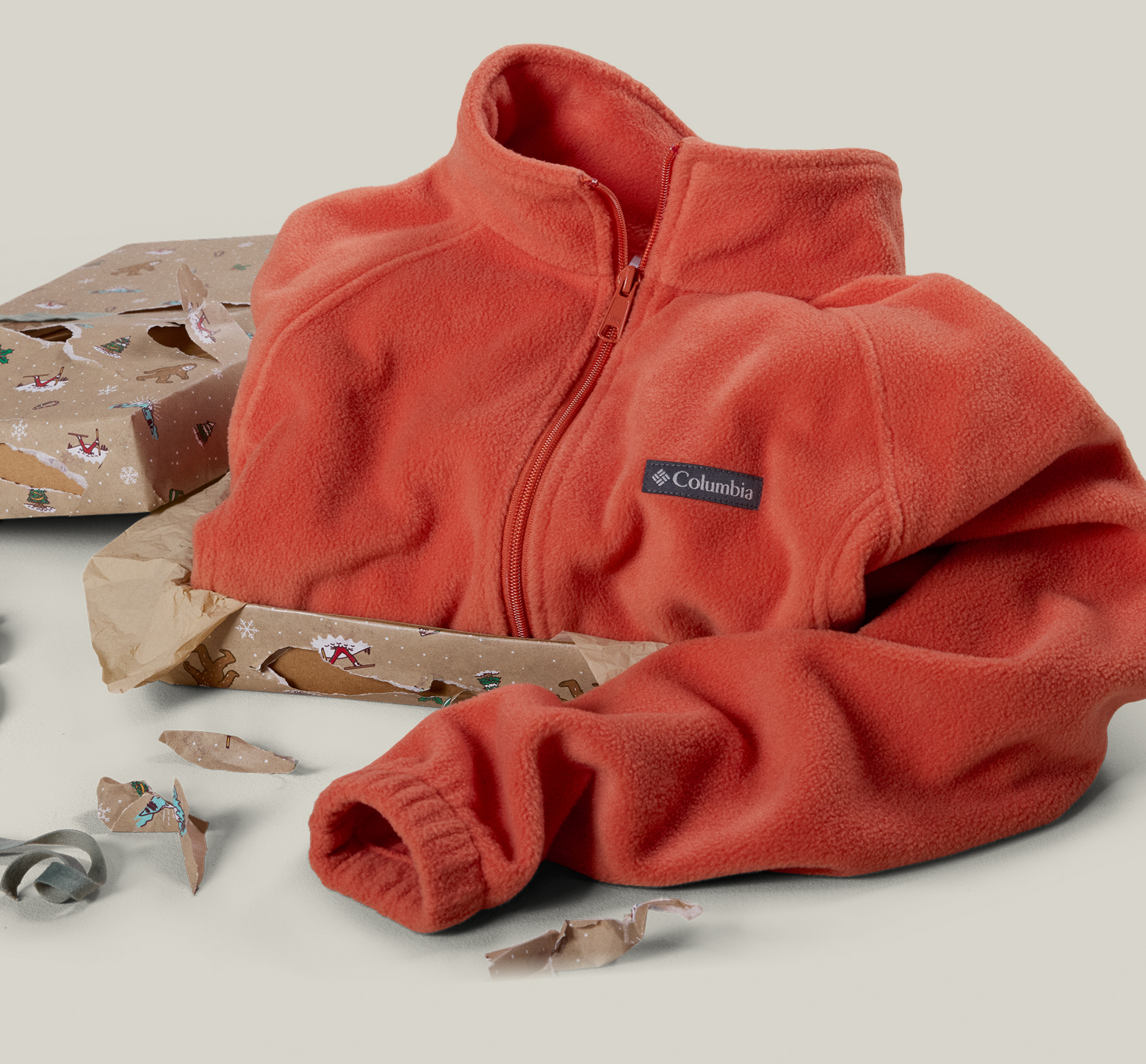 An image of wrapped and unwrapped gifts and fleece with text that says: LAST-MINUTE GIFTS OUTERWEAR UP TO 50% OFF