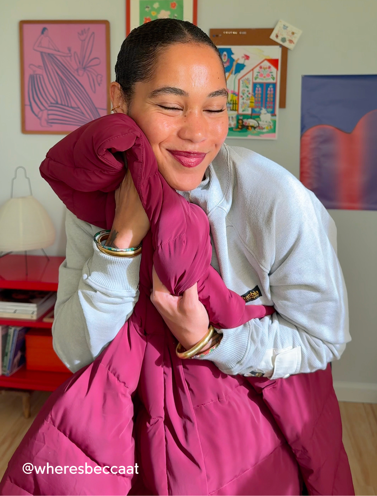 A woman nuzzling the pink Amaze Puff