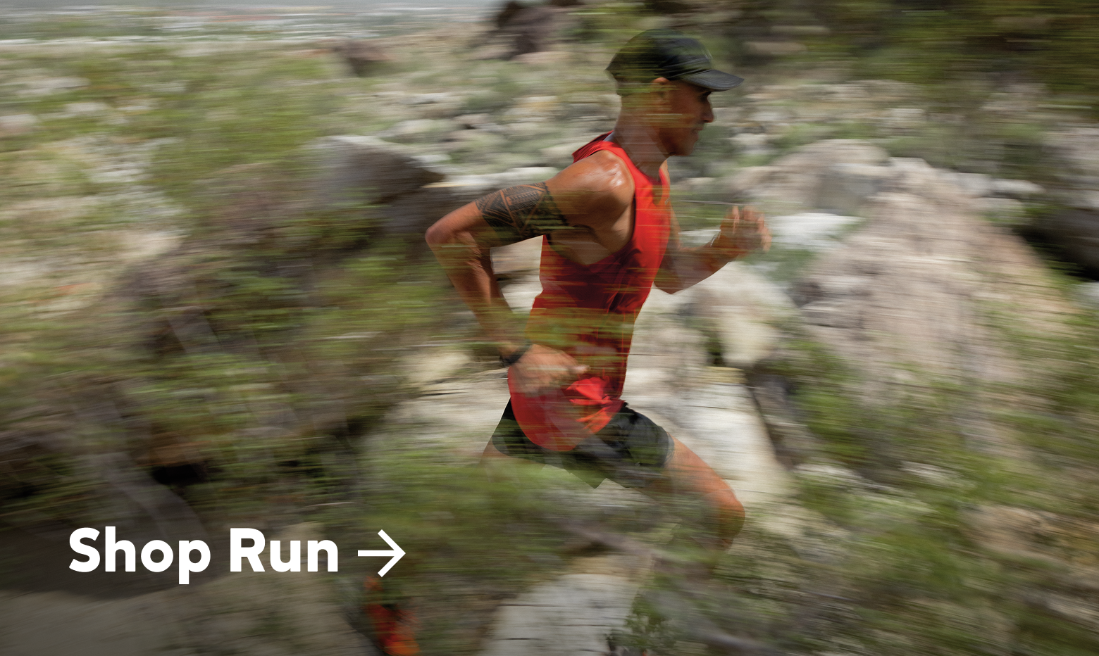 A person running on a green and rocky trail
