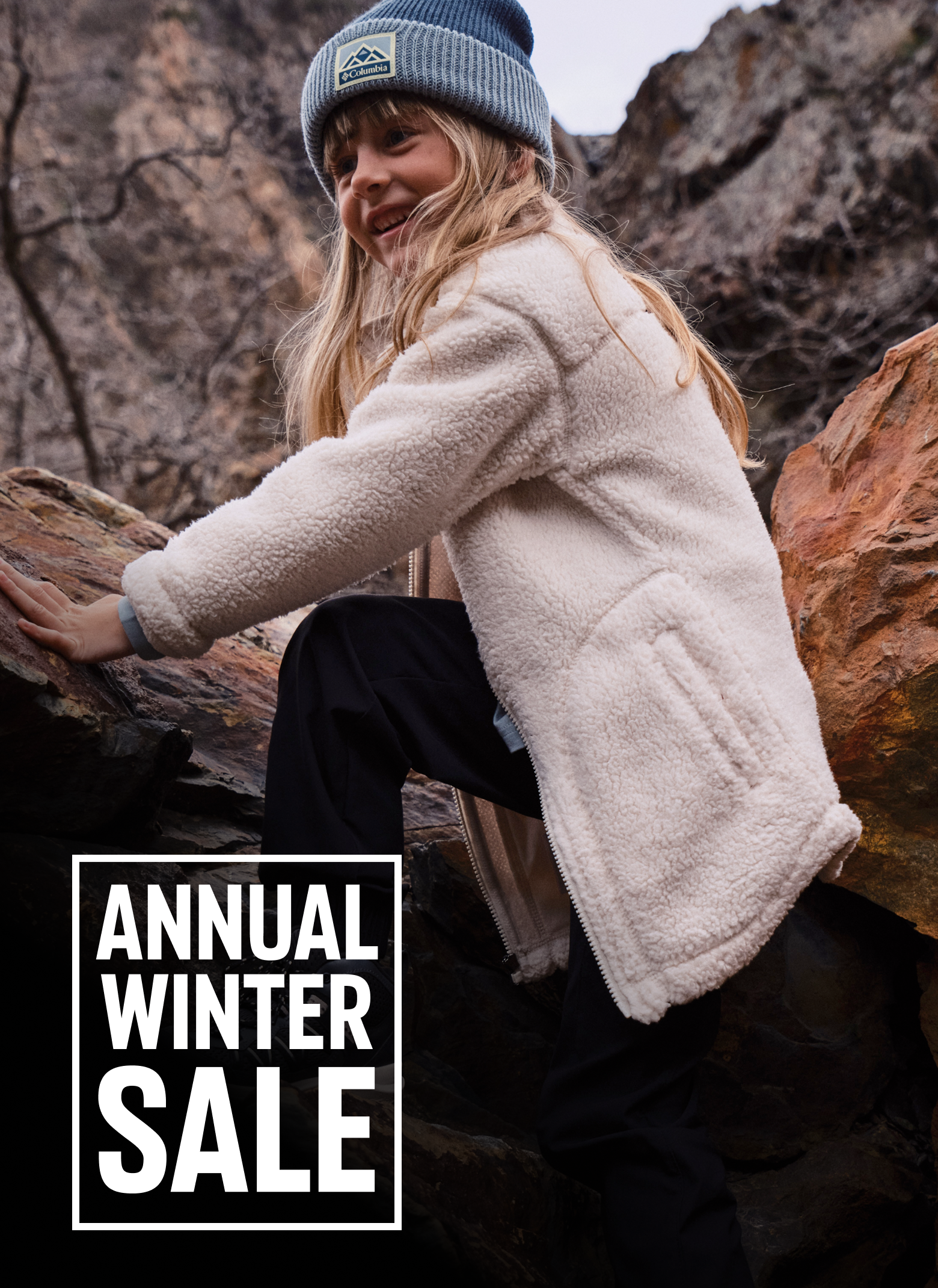 A kid climbing over rocks wearing a fleece and beanie. Text says ANNUAL WINTER SALE UP TO 40% OFF NEW STYLES ADDED