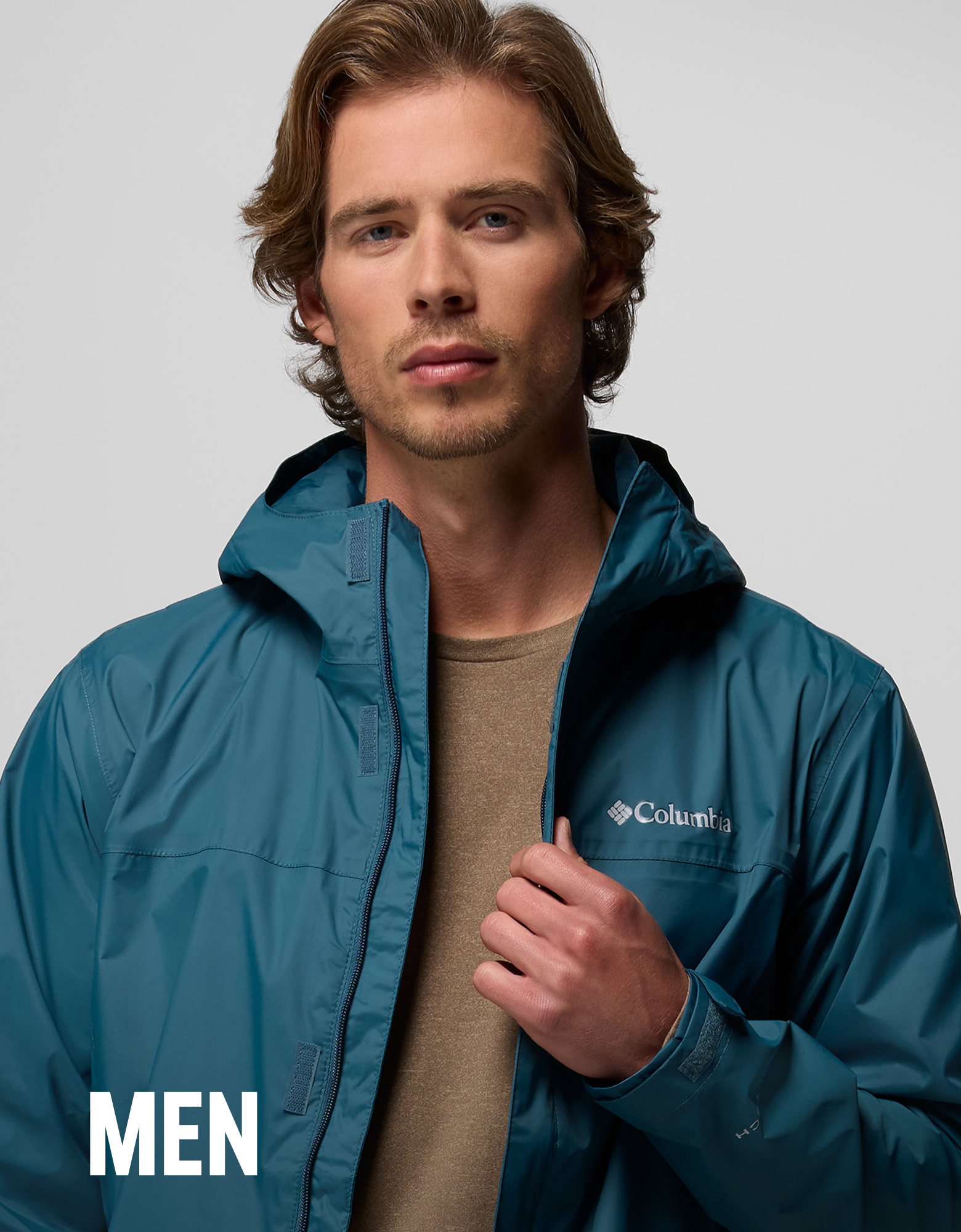 A man wearing a blue rain jacket with text overlay 
