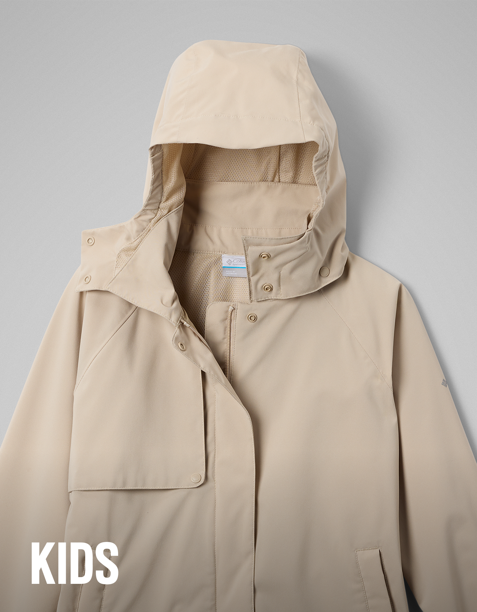 A kids' beige rain jacket with text overlay 