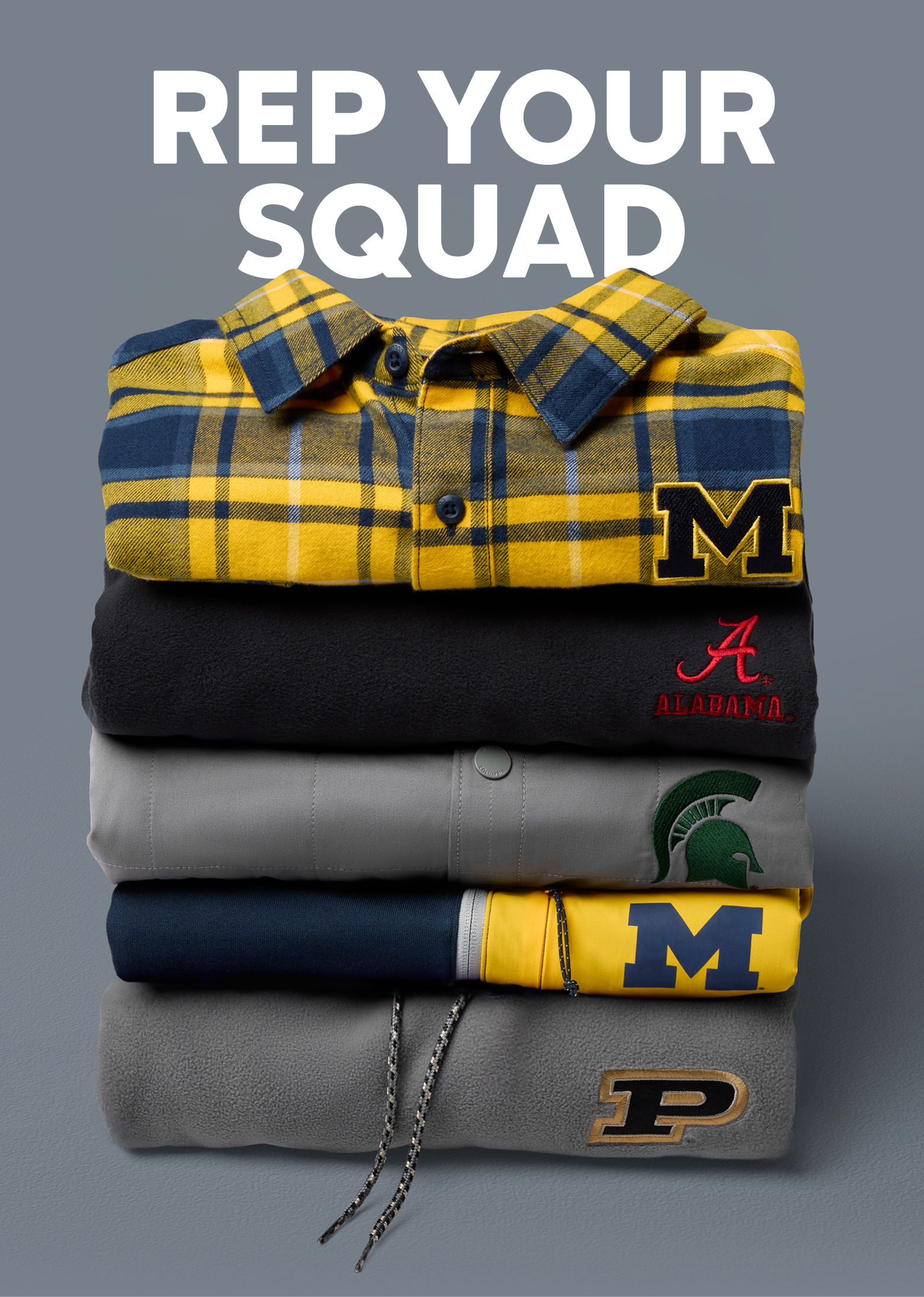 A neat stack of folded collegiate button ups, jackets, and sweaters with school logos on the right side. 