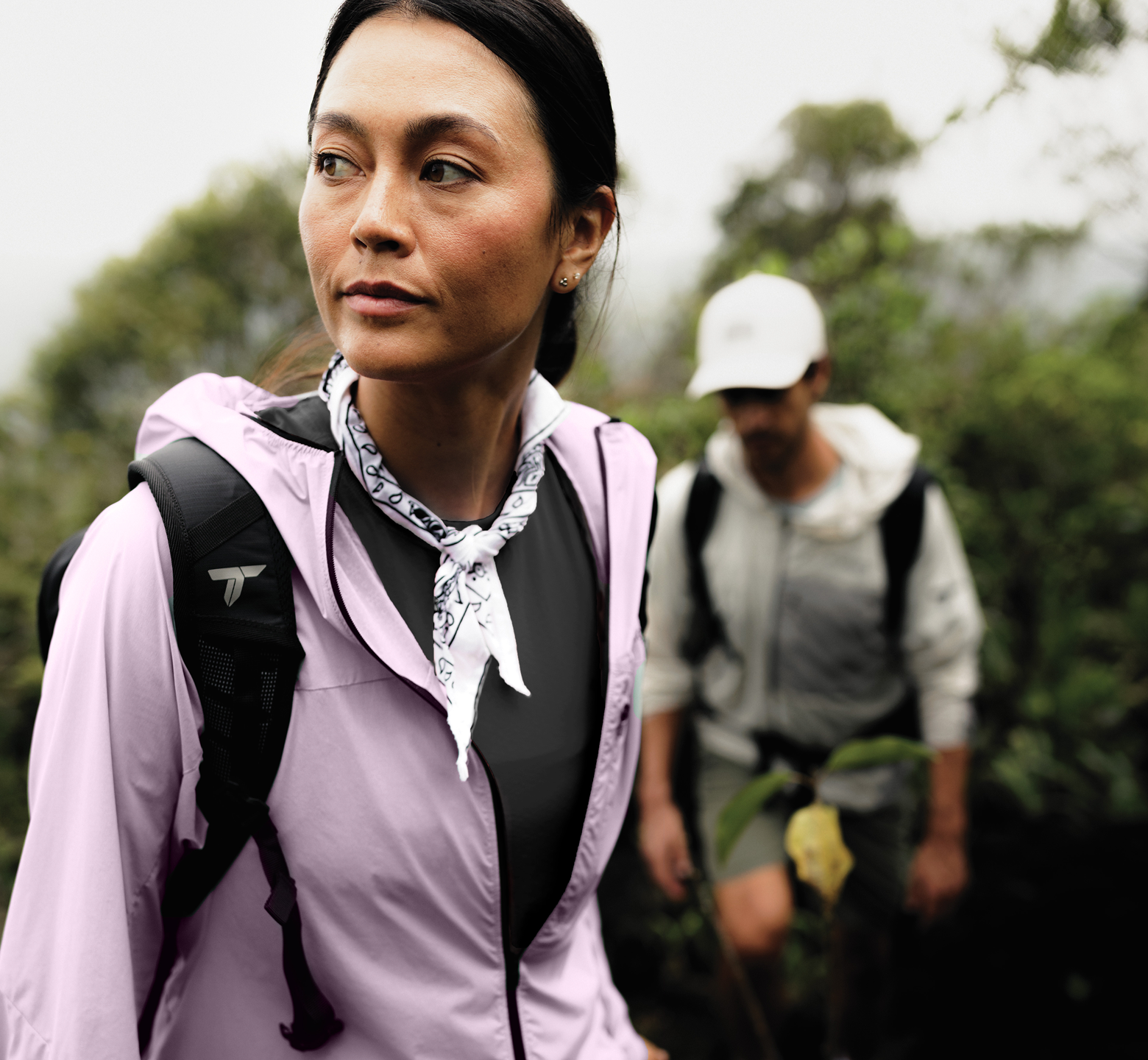 A man and woman on a cloudy spring hike