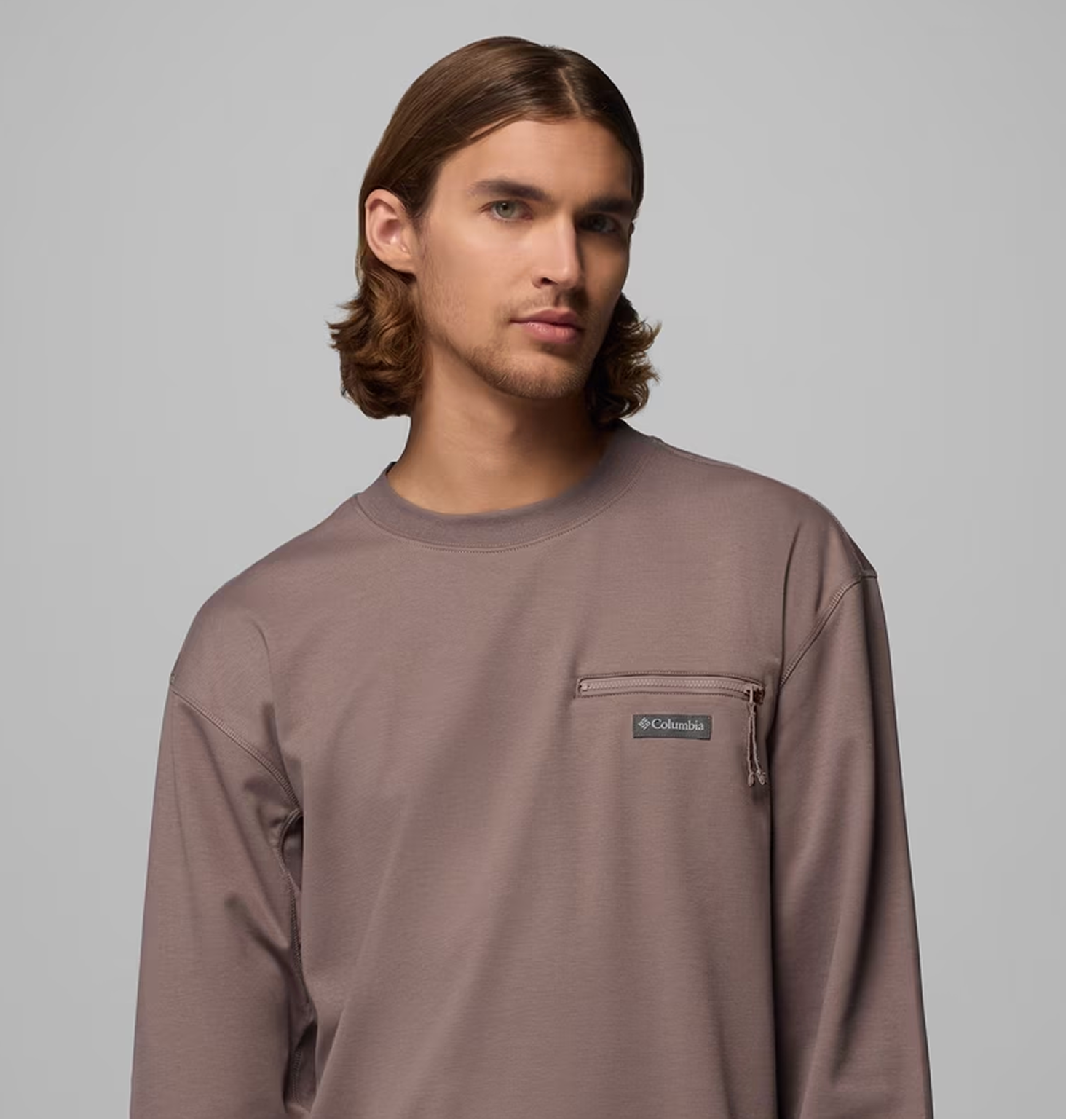 A man wearing a mauve long sleeve shirt.