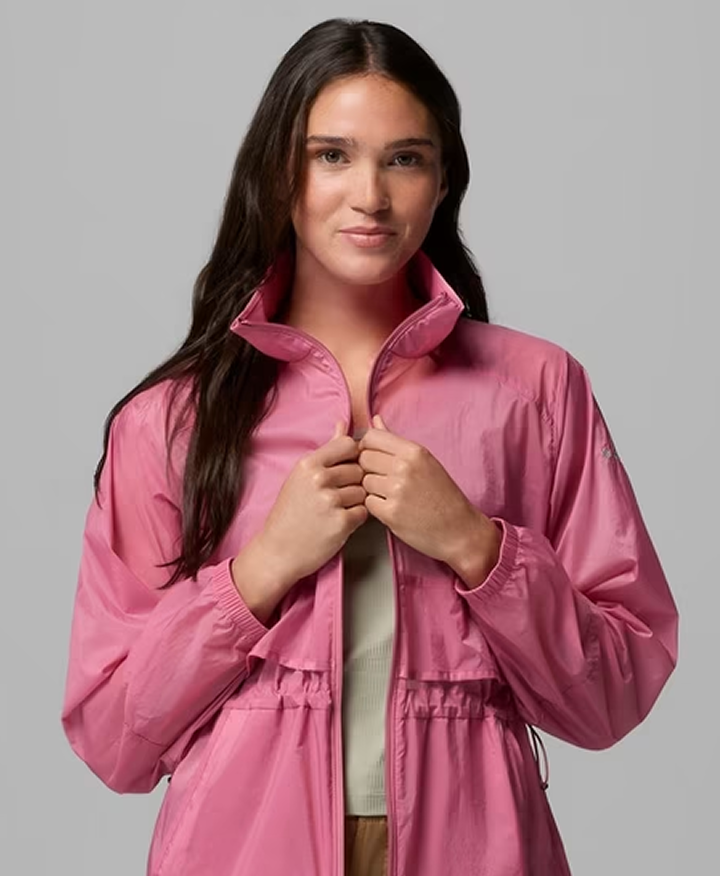 A woman wearing a pink windbreaker.