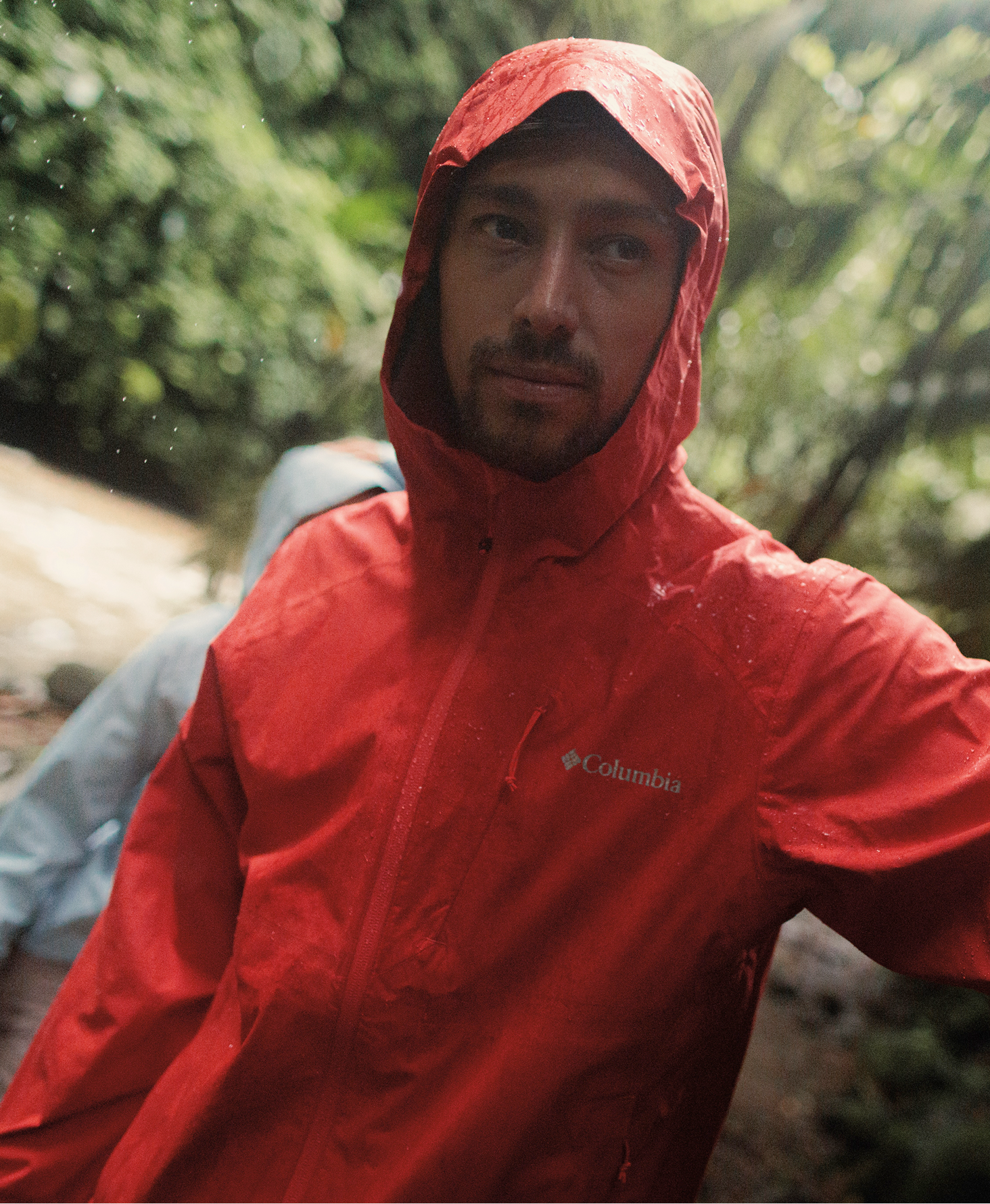 A man wearing a red rain jacket.