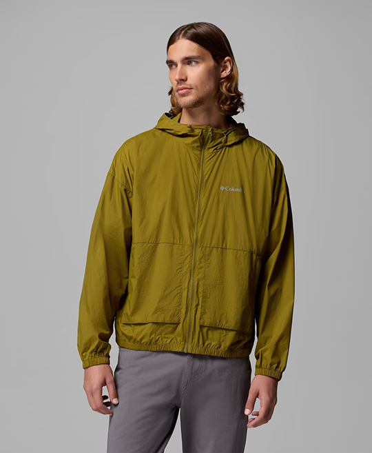A man wearing a green windbreaker.