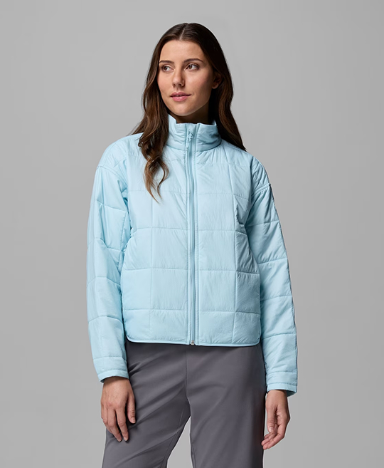 A woman wearing a light blue insulated jacket.