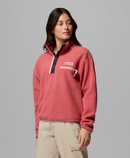 A woman wearing a pink fleece pullover.