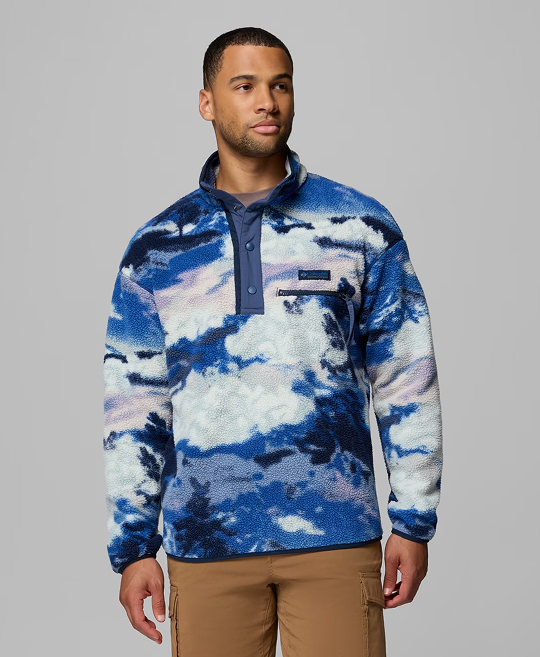 A man wearing a blue printed fleece pullover.