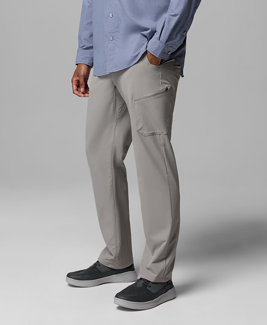 Waist-down image of a man wearing green pants and hiking boots.