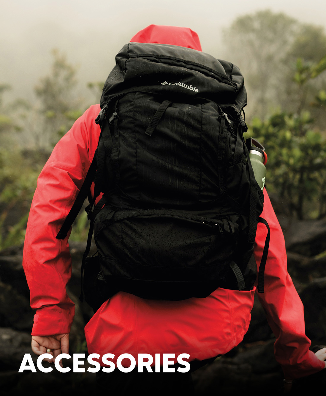 A hiker walking away wearing a bright red rain jacket and black backpack with text: ACCESSORIES