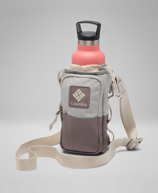 A pink water bottle in a tan water bottle sling.