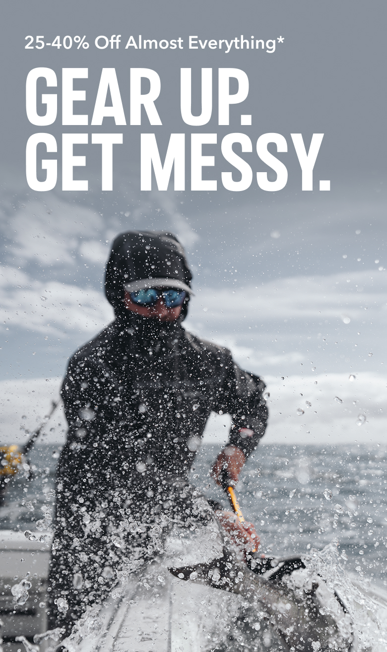 An angler reeling in a fish, wearing a black jacket with the hood up and sunglasses on, with text: 25-40% Off Almost Everything* GEAR UP. GET MESSY.