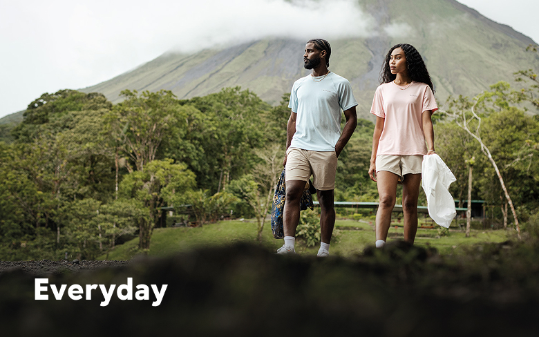 A man and a woman walking through a lush jungle landscape with a mountain in the background with text: Everyday