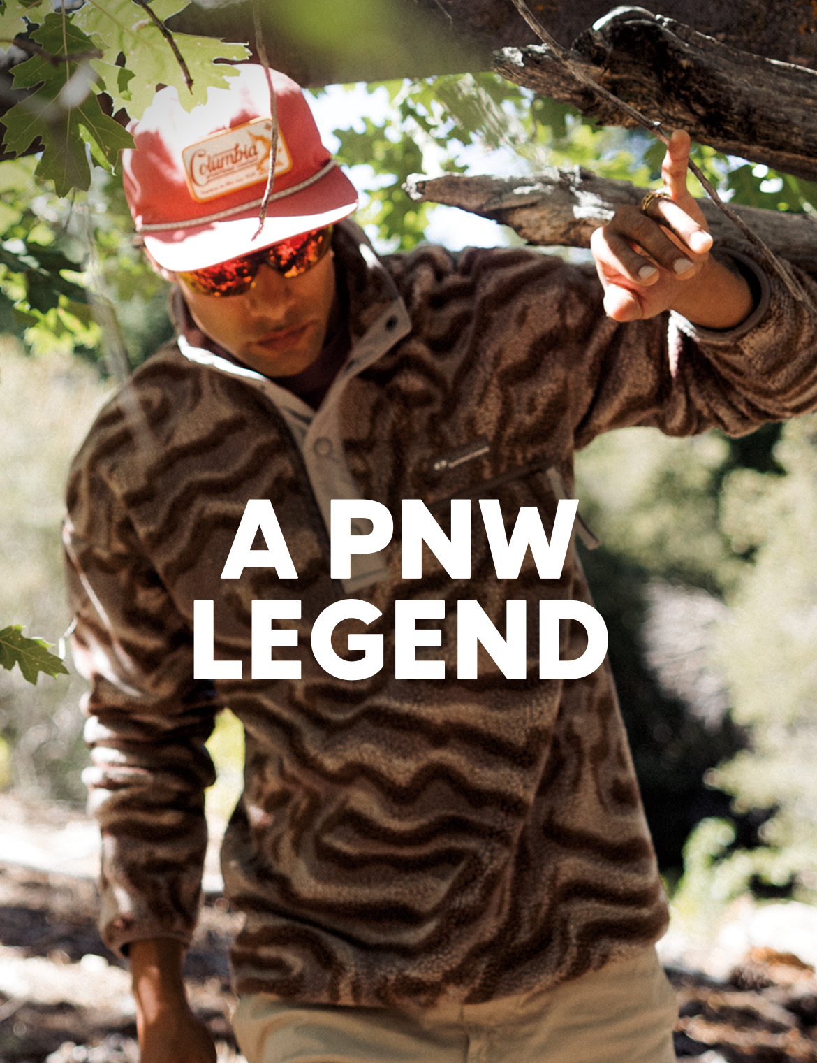 Headline reads: A PNW Legend. Image of a man wearing a Helvetia fleece as he walks through a forest.