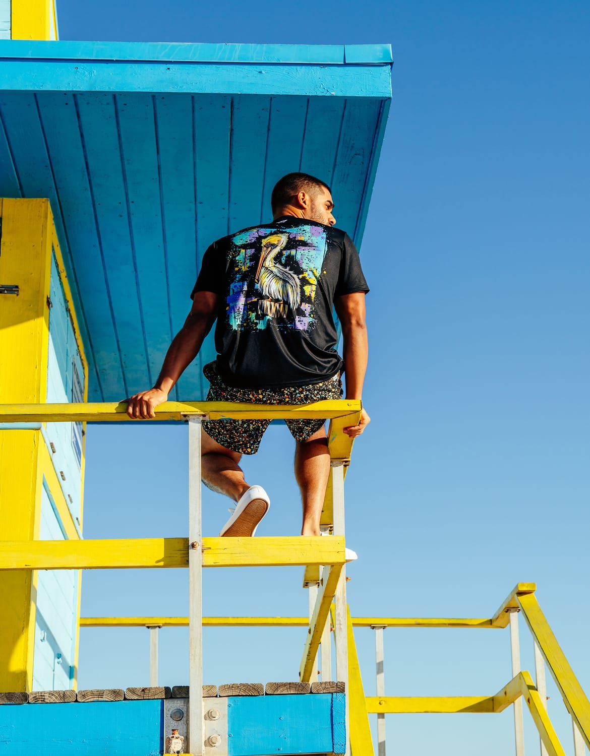 Man on a lifeguard tour wearing a shirt with a Bentley print.