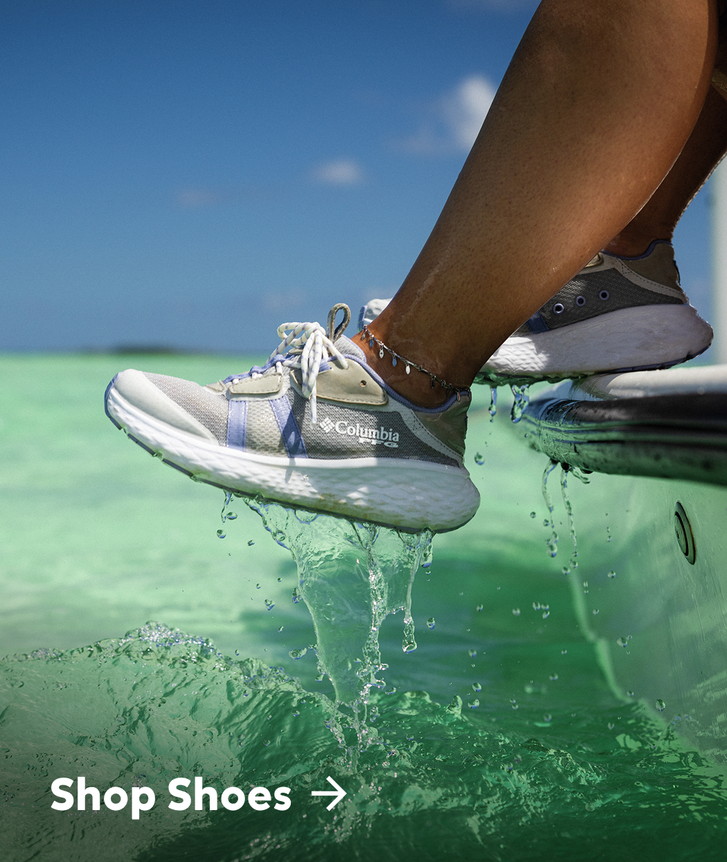 Close-up of a woman's sneakers as she rests them on the side of a boat with text: Shop Shoes