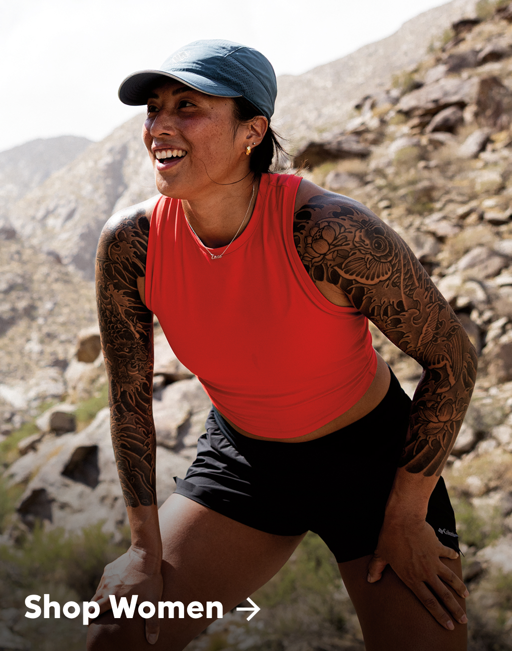 A woman trail running and smiling. 
