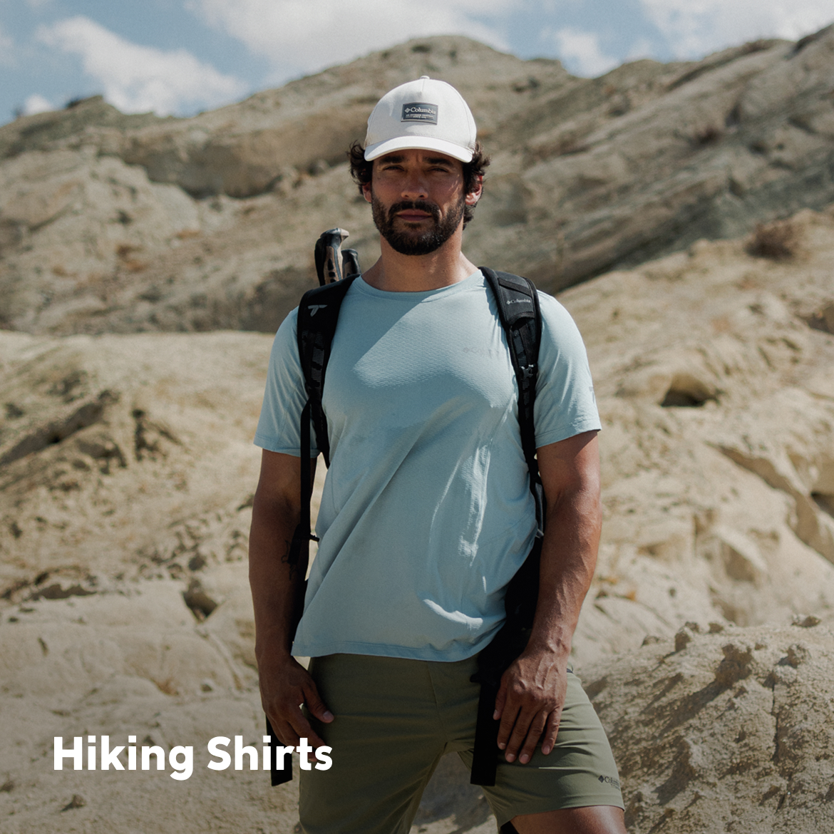 A man on a hike with a rocky background. HIKING SHIRTS