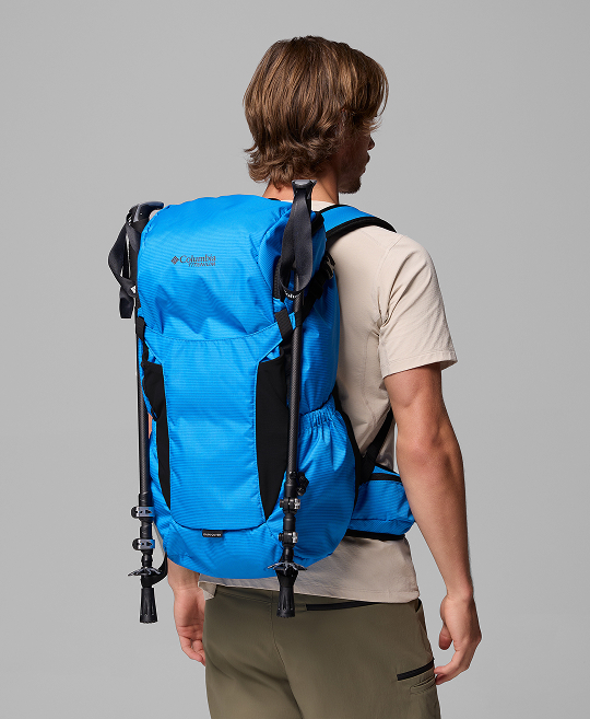 A man wearing a blue hiking backpack