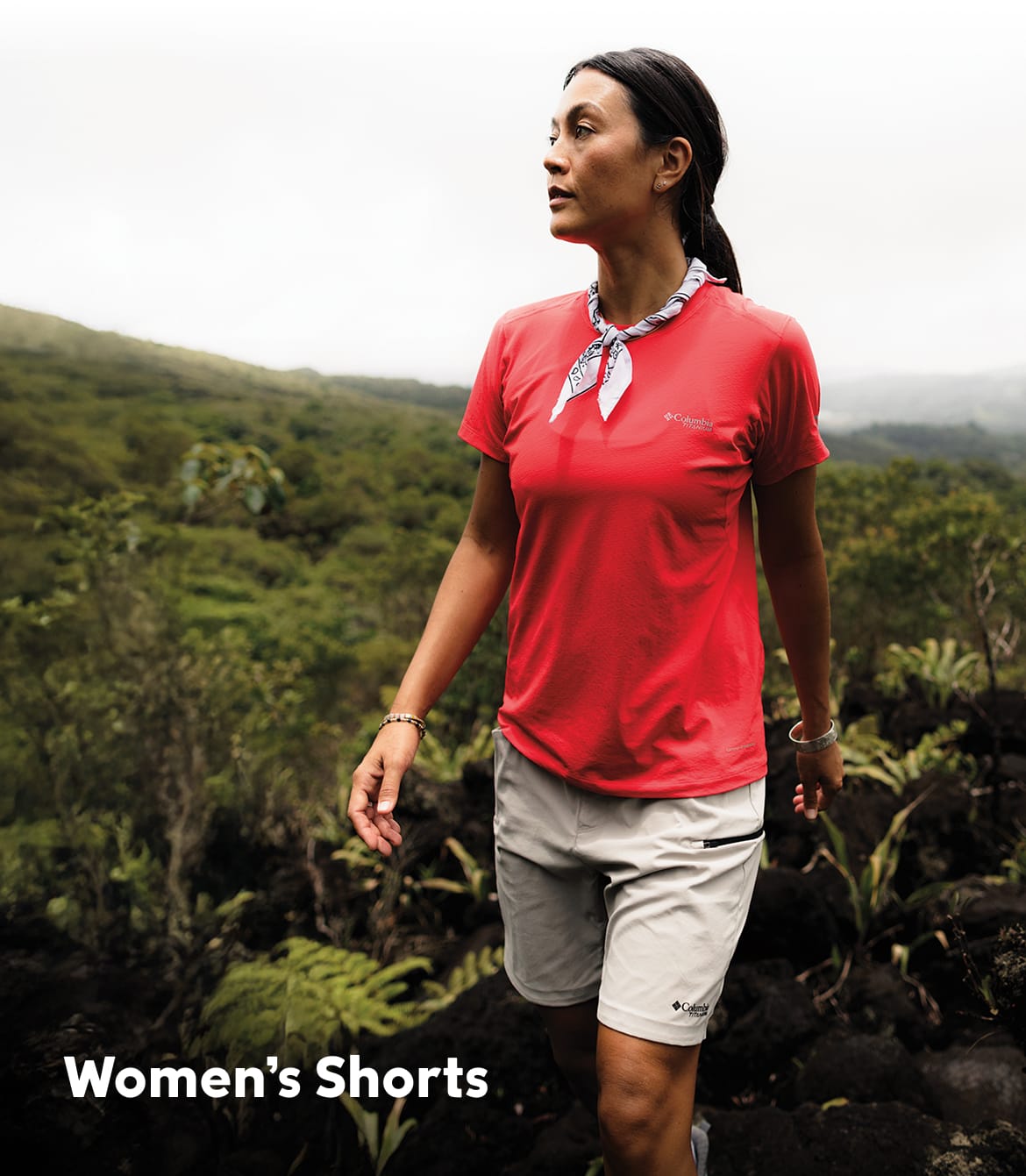 A woman hiking with text that says Women's Shorts